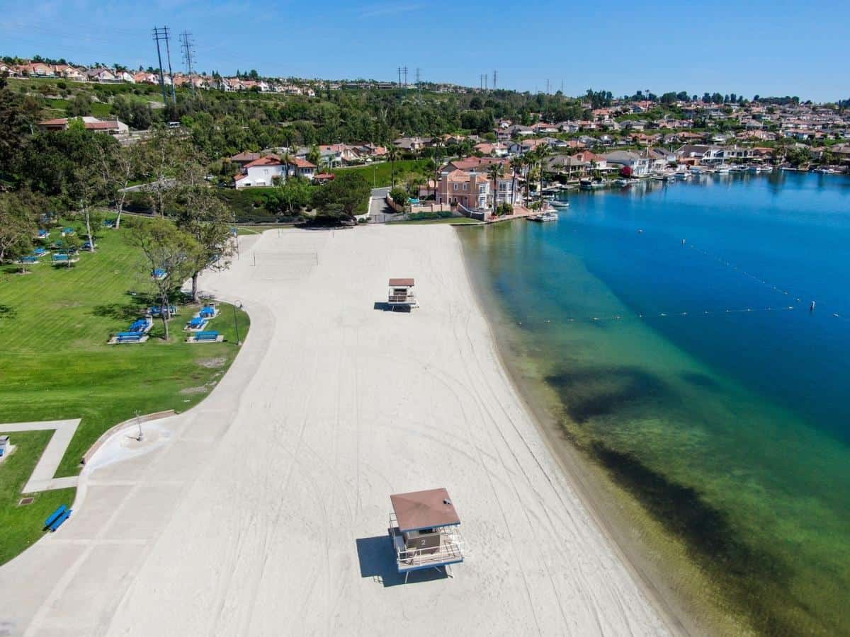 Aerial view of Lake Mission Viejo with recreational facilities and beach Playa Del Norte. California - California Places, Travel, and News.