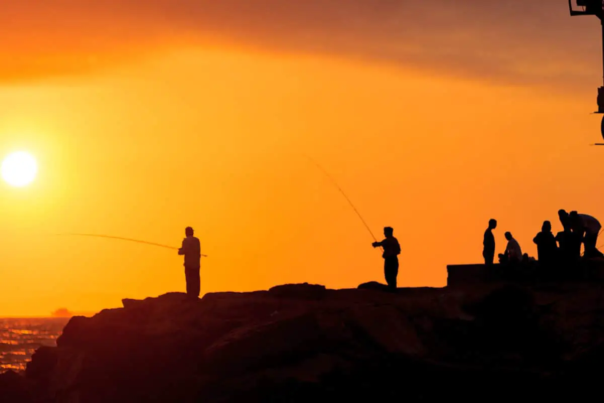 Silhouette Of Men Fishing On The Pier Off Balboa Island Newport Beach At Sunset In Southern California. - California View