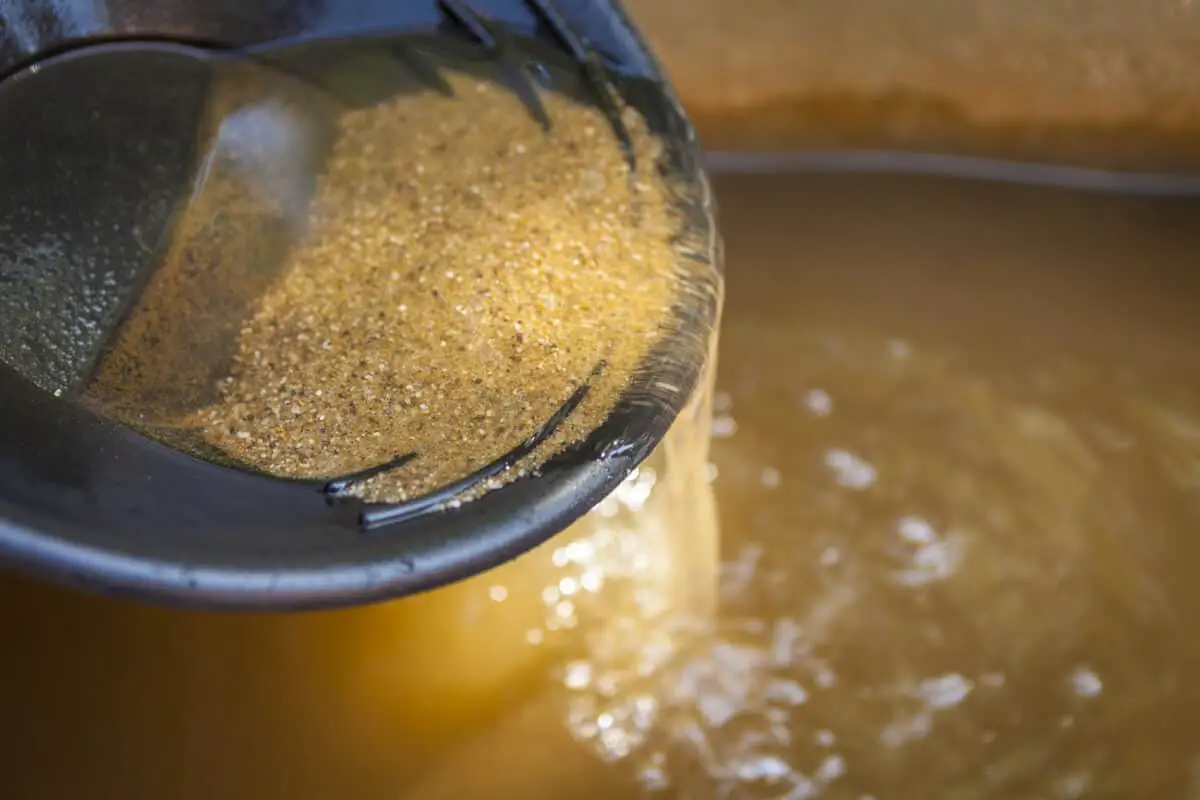 Close up of gold panning pan with sifting sand - California Places, Travel, and News.