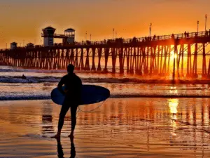 A Silhouetted Surfer Waits For The Perfect Set - California View