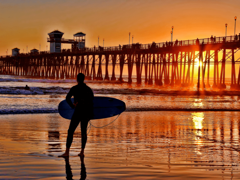A silhouetted surfer waits for the perfect set - California Places, Travel, and News.