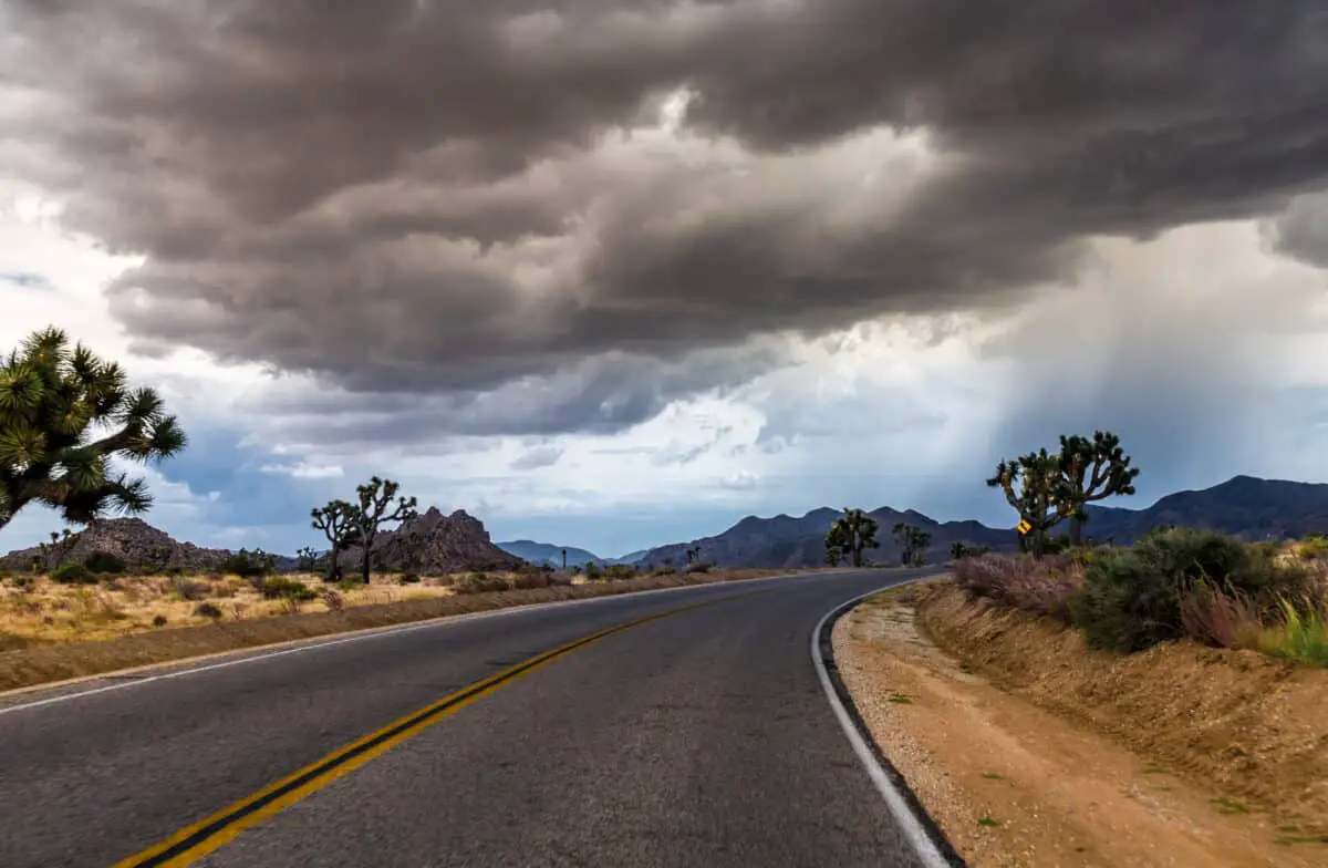 Heavy Storm Front With Dangerous Dark Clouds Above The Road At The Joshua Tree National Park In California - California View