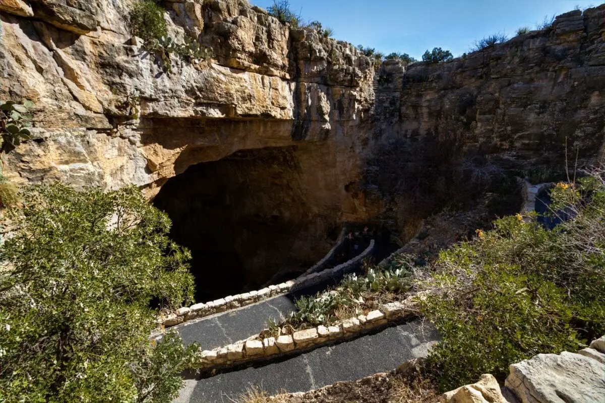 Switchback footpath winds into natural opening of Carlsbad Caverns Entrance. - California Places, Travel, and News.
