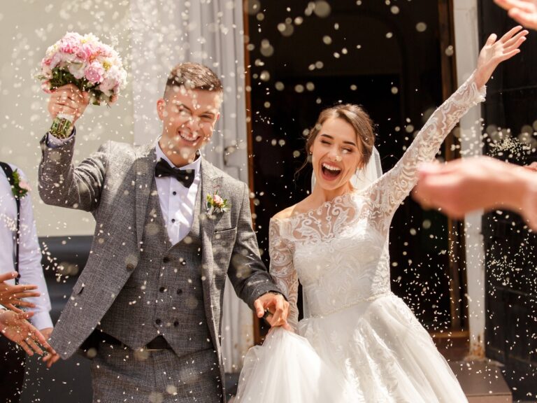 Happy wedding photography of bride and groom at wedding ceremony. Wedding tradition sprinkled with rice and grain - California Places, Travel, and News.