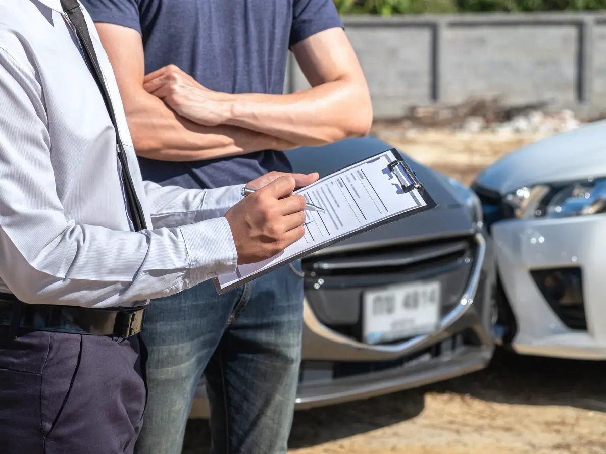 Insurance Agent Examining a Car Accident - California Places, Travel, and News.