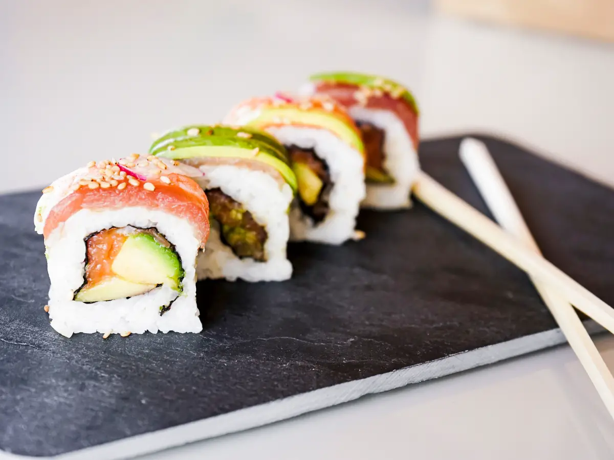 Variety of Sushi California Rolls with Chopsticks - California Places, Travel, and News.