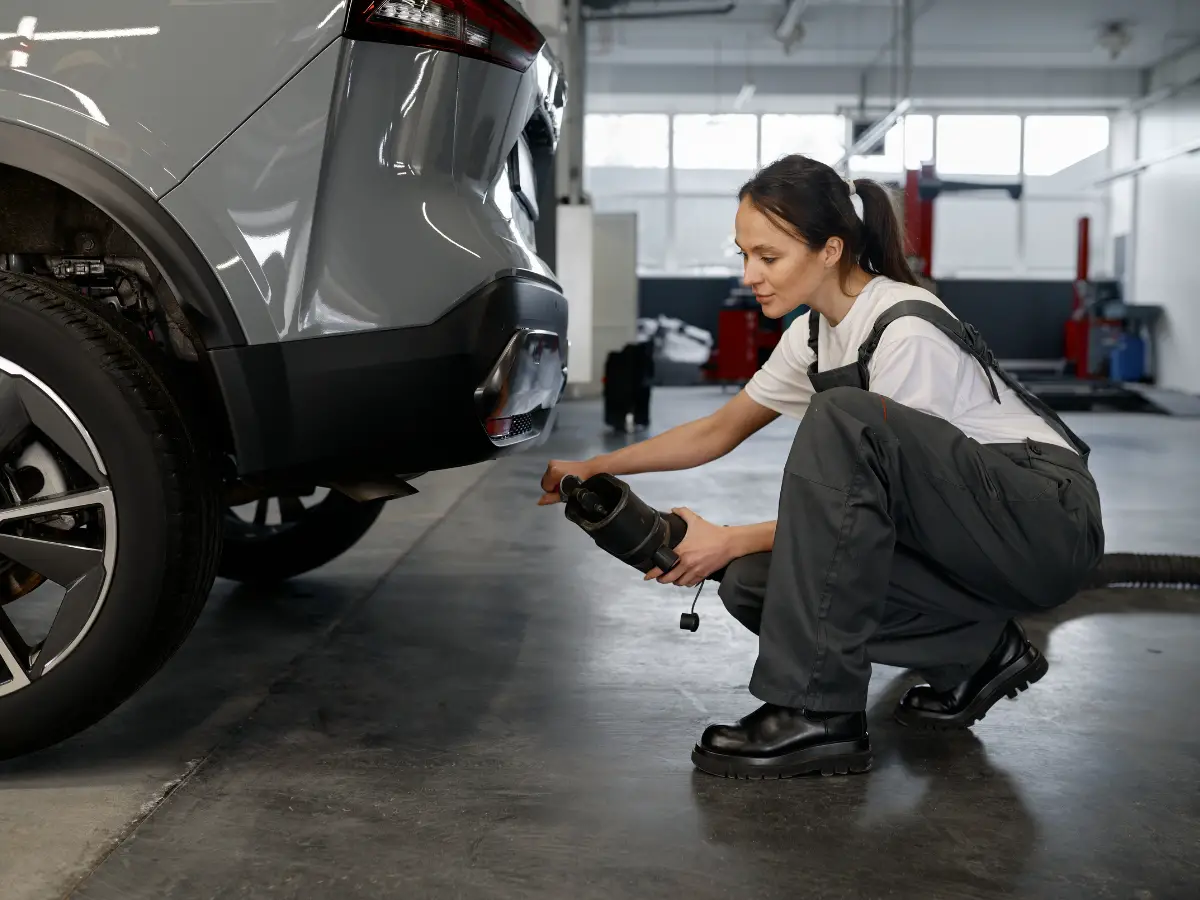 Woman Mechanic Testing Car Traffic Fumes Emission - California Places, Travel, and News.